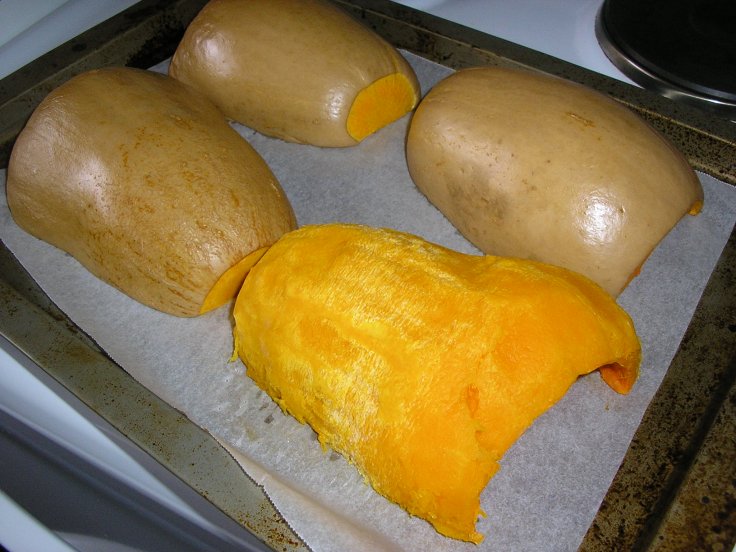 Baked pumpkins. One has been peeled.